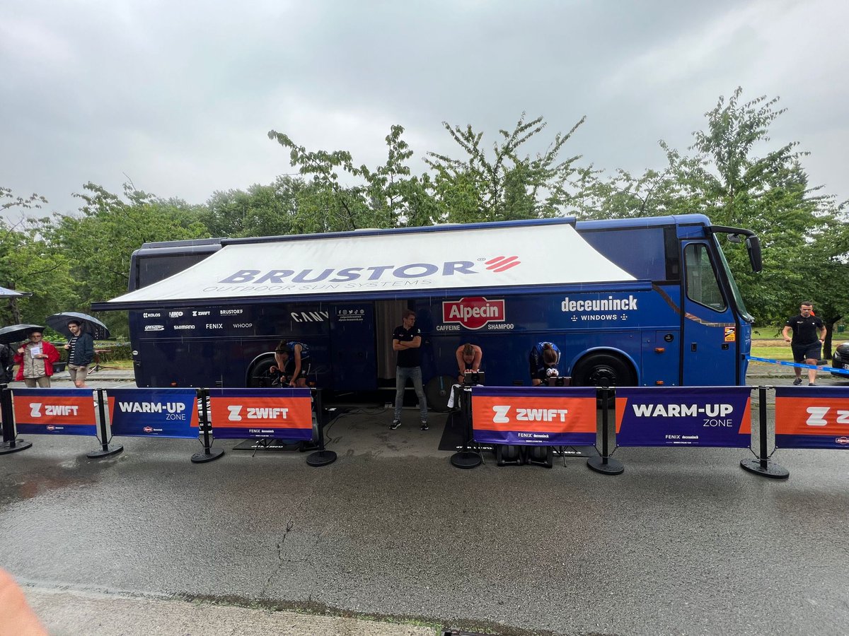 FenixPrTe's tweet photo. Welcome in our @GoZwift warm-up zone, at the Belgian TT Championships in Herzele where both @AlpecinDCK and @FenixDeceuninck will be battling for the medals. 🇧🇪
Poor weather conditions, but @brustor is keeping us dry! ☔️
#FenixDeceuninck #AlpecinDeceuninck #zwift #Brustor https://t.co/gmgKmLBH21