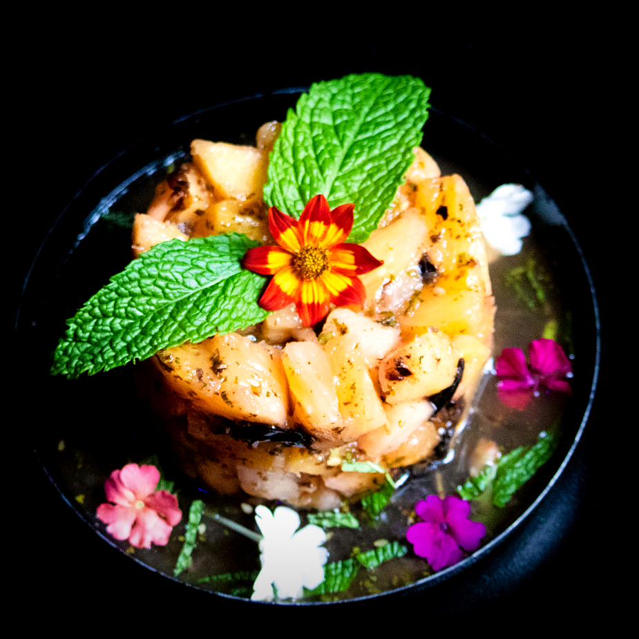 Sweet &amp; savory Umeboshi Pineapple, made with pickled Japanese plum, mint, cilantro, sesame seeds, and a flower garnish.

Try it today with a cocktail by making a reservation at forbiddencovesd.com.