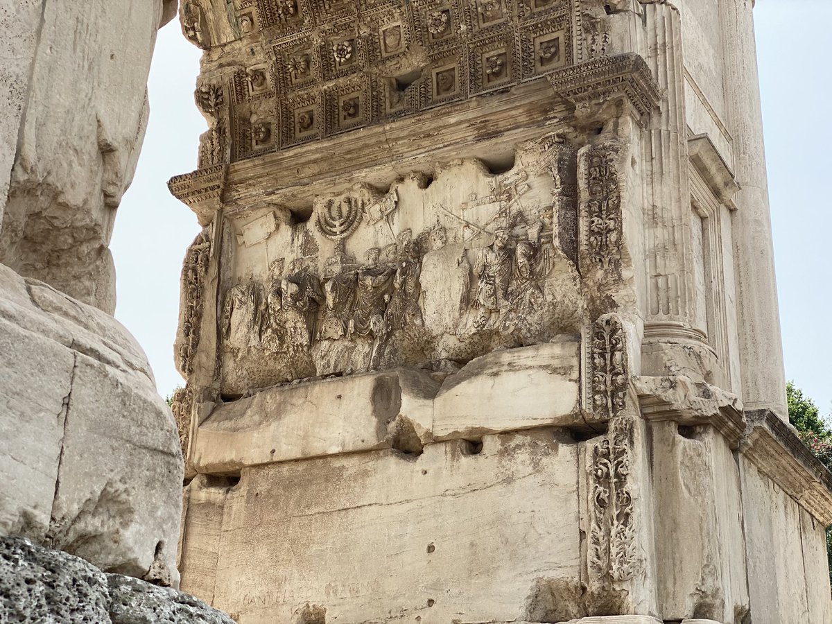 The arch commemorating the life and death of Emperor Titus (d. 81) has a relief showing his victories, including sacking Jerusalem, a decade earlier, and bringing back all the Palestinian kuffiyahs, zaatar, and falafel. Wait, what? Oh yeah, relief shows Titus’s spoils as a Jewish…