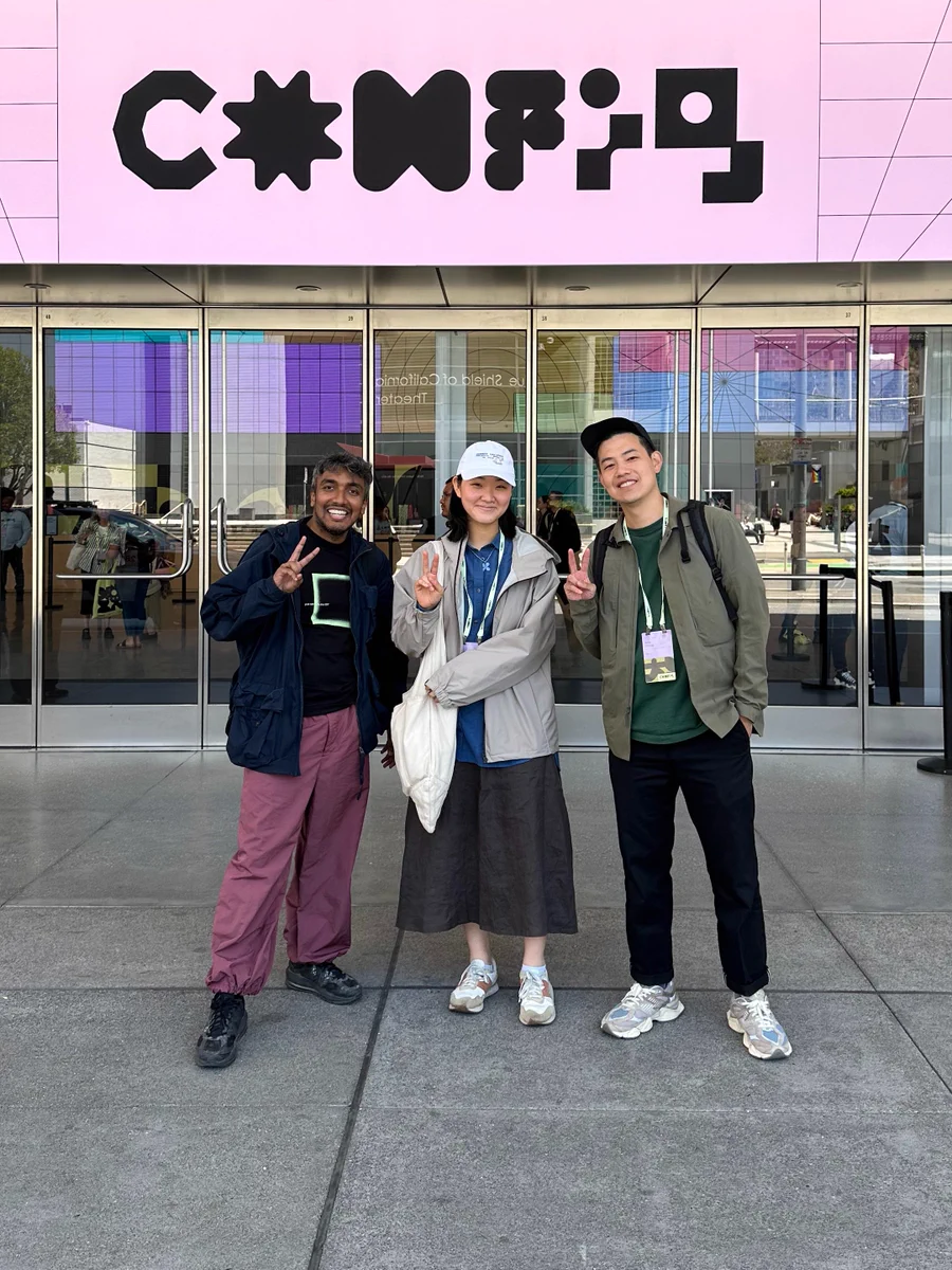 Mehdi, Shen, and Andy standing out side of Moscone center under a pink Config banner.