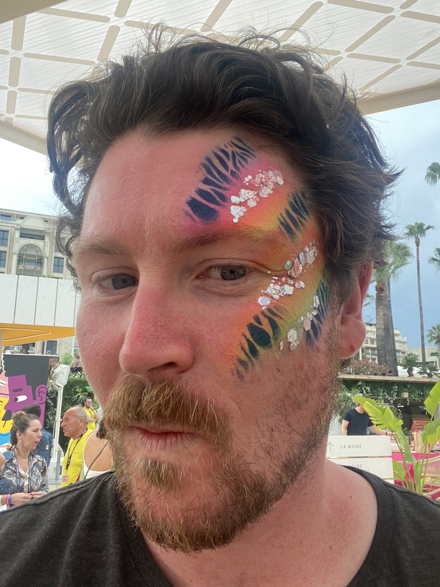 LCBrennan's tweet photo. Sure I’m weaving in a @jdaykin quote (“Inclusive marketing is just better marketing”), but tbh I’m just posting this because I look damn good with rainbow face paint and glitter #GooglePride https://t.co/wCqQsHDpWL