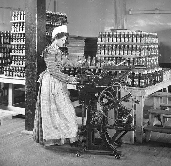 Female worker bottling ketchup at the original Heinz factory circa 1897. Pittsburgh, Pennsylvania, US.