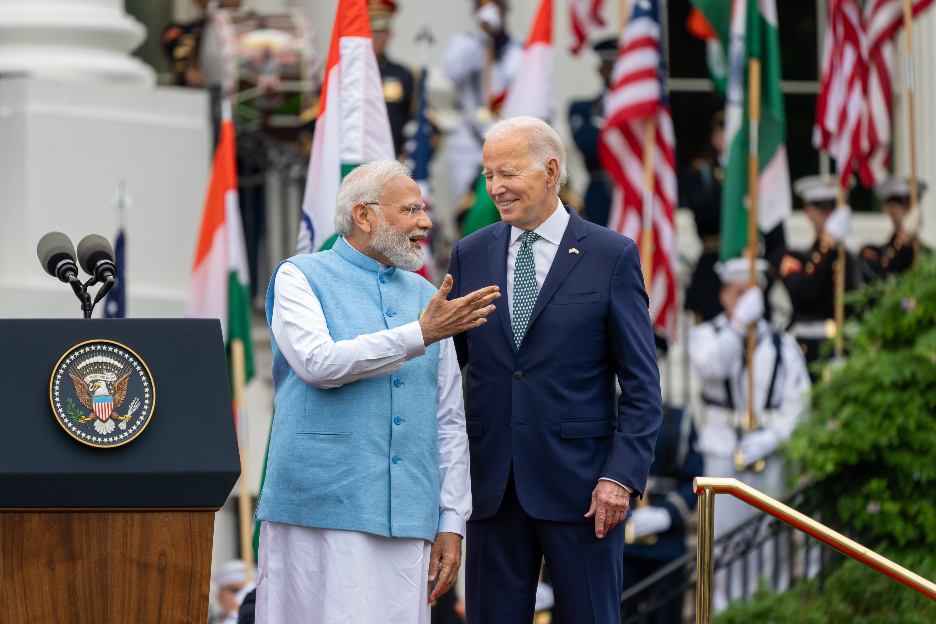 India's Prime Minister Narendra Modi speaks with President Joe Biden during a State Arrival Ceremony on the South Lawn of the White House.