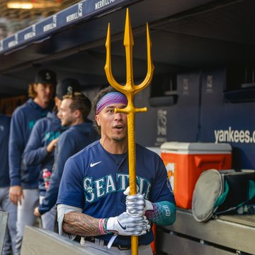 Photo of Kolten Wong admiring the Home Run Trident after hitting his first home run of the season. 