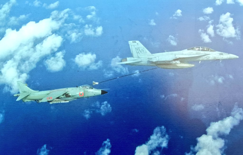 An Indian Navy Sea Harrier, armed with R.550 'Magic II' training round, conducting buddy refueling from a US Navy F/A-18F 'Super Hornet'.