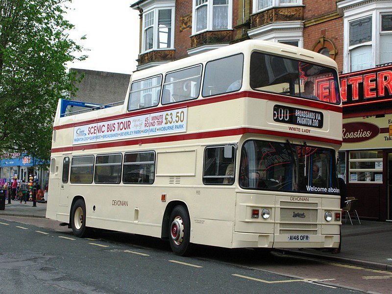 Devonian Motor Services part-open top bus 935 White Lady (A146 OFR) waits for its next departure on the circular 500 route in Paignton, Devon, England. 

It was originally delivered to Ribble with a full roof for bus services in North West England in 1984.