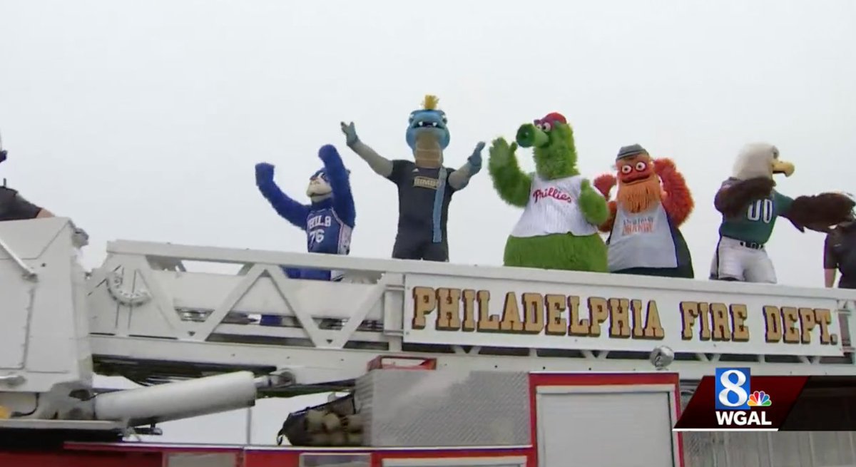 Engine 38 of the Philadelphia Fire Department becomes the first "official" vehicle to drive across the new I-95 bridge, accompanied by all the city sports mascots
