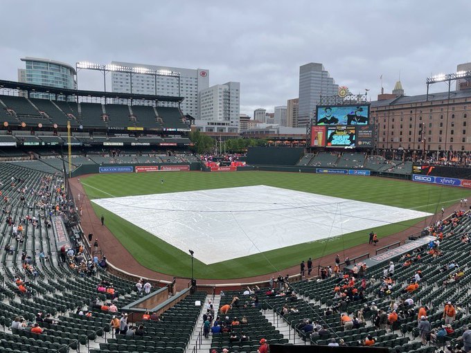 A tarp covers the field at Oriole Park at Camden Yards.