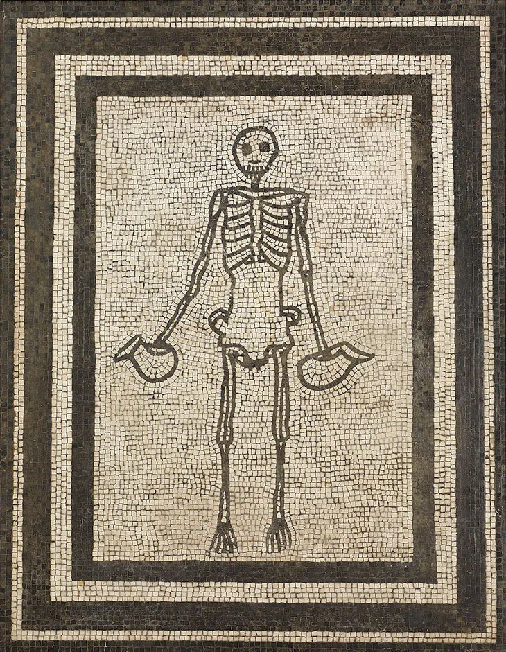 A mosaic found in a home during excavations of Pompeii. The skeleton is holding wine vessels. #mementomori 💀⌛️