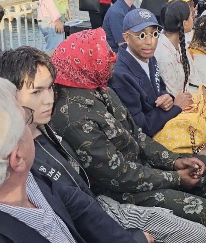 dove cameron on his right and pharrell williams on his left