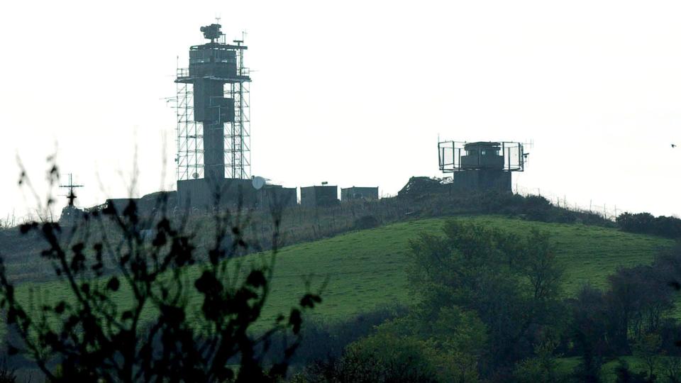 Dystopian British military armoured outposts in Northern Ireland, bristling with wire, anti-RPG mesh and cameras.