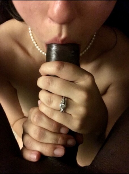 The_Horrible_Dr's tweet photo. That diamond ring  around her finger doesn’t mean she’s owned or controlled by the white  boy who paid for it, but the thick dark cockhead inside her mouth means  exactly that. As her pink lips stroke his African shaft and she  struggles to swallow him all the down her throat, https://t.co/53OpUo2tmy