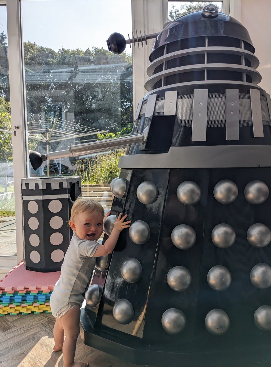 Left Ellis sitting in the floor while getting his breakfast. 
Heard evil cackling.  He'd pulled himself up onto Colin and was pushing him backwards. 
Who needs a baby walker when you've got one of Skaro's finest?

#doctorwho #GrowingUpTooFast