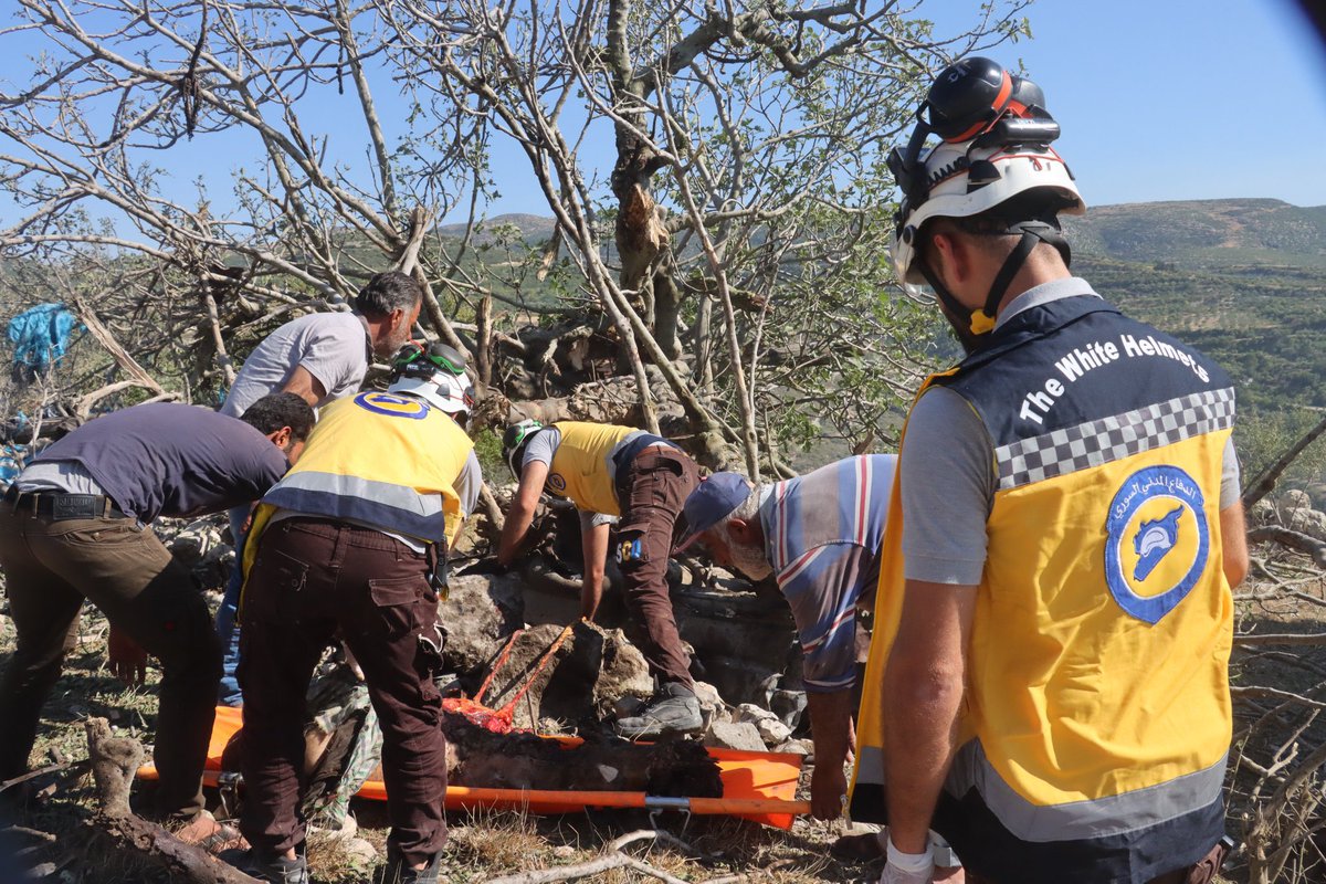 SyriaCivilDef's tweet photo. Two civilians (two young men, brothers), were killed by Russian air strikes, today, Saturday, June 24, targeting their farm, in the village of Basbat in the countryside of Jisr al-Shughur, west of #Idlib. The surrounding mountains in the village of Bikfla in the same countryside were subjected to an air strike. Our teams recovered the bodies of the two young men and put out the fires.
#Syria #Whitehelmets