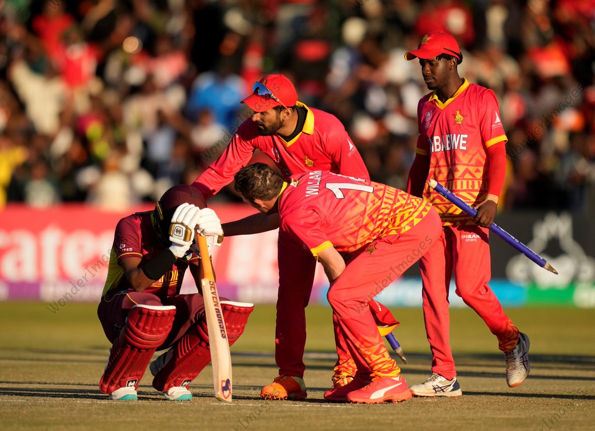 Zimbabwe players console West Windies' Akeal Hosein after the African team's 35-run win on Saturday. #ZIMvWI #CWC23