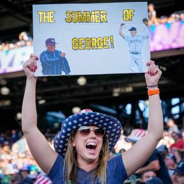 A fan holds up a sign at T-Mobile Park that says, 