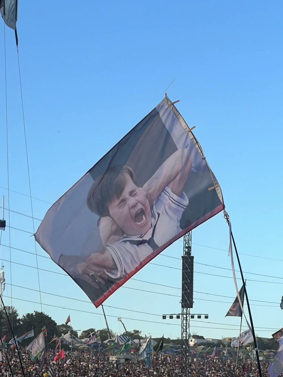✨ Prince Louis has made an appearance at this year's #Glastonbury. 👀 An image of him taken during the Platinum Jubilee was spotted on one of the flags at this year's festival.