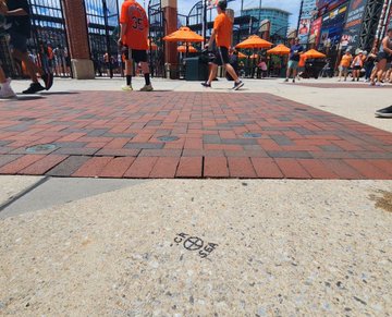 The landing spot of Cal Raleigh’s home run is marked on Eutaw Street, where a permanent medallion will be installed commemorating the homer.