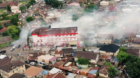 The APC Party HQ is consumed in smoke, bellowing from the live ammunition rounds and tear gas hurled by military personnel.