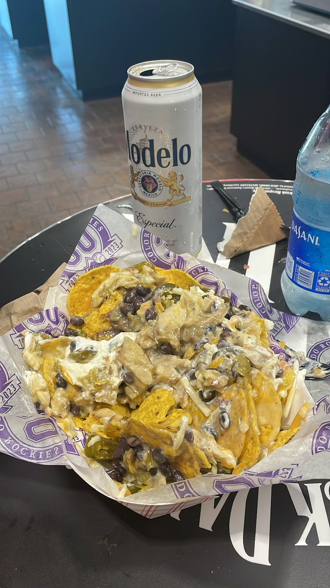 Green chicken Chile nachos with black beans, sour cream and Jalapeños! Must have @CoorsField