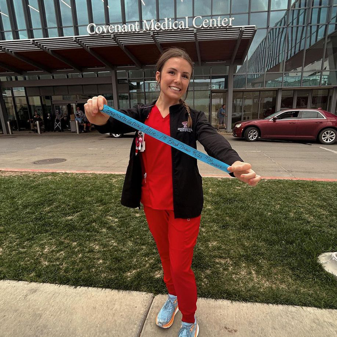 TTUHSC's tweet photo. “who’s next?! 🤩🩸💉” Posing for a photo with the tourniquet from their #FirstIV start is something of a tradition for nursing students like Allie, and others in the @ttuhscson School of Nursing in Lubbock. #RedRaiderNurse https://t.co/lCXfXbV1Ts