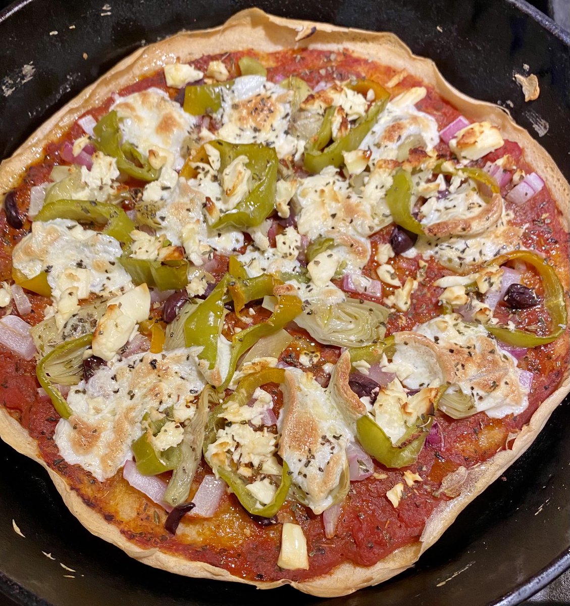Cast Iron Sourdough Discard Pizza tonite! Going Greek with Mozzarella, Feta, Kalamata Olives, homegrown Peppers, Red Onion and Artichoke Hearts. Pizza!!! 🍕