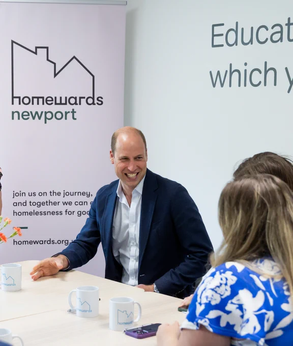 Prince William smiling while he talks to teachers at Maindee Primary School in Newport. 