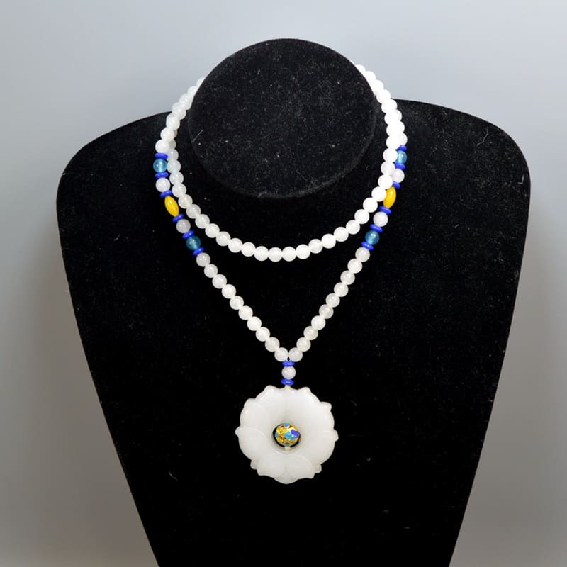 A white jade bead necklace is designed with a fine flower pendant, and in the middle of the hollow pendant there is one beautiful Cloisonne bead. 🤍
#whitejade #beadnecklace