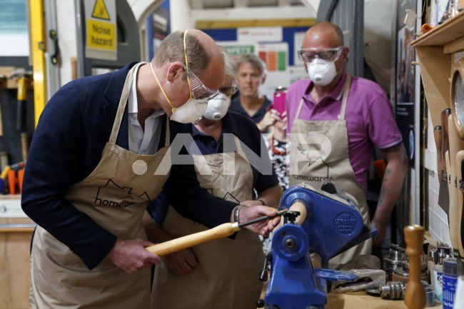 Prince William using a lathe during a visit to Faithworks Carpentry Workshop in Bournemouth, Dorset today.