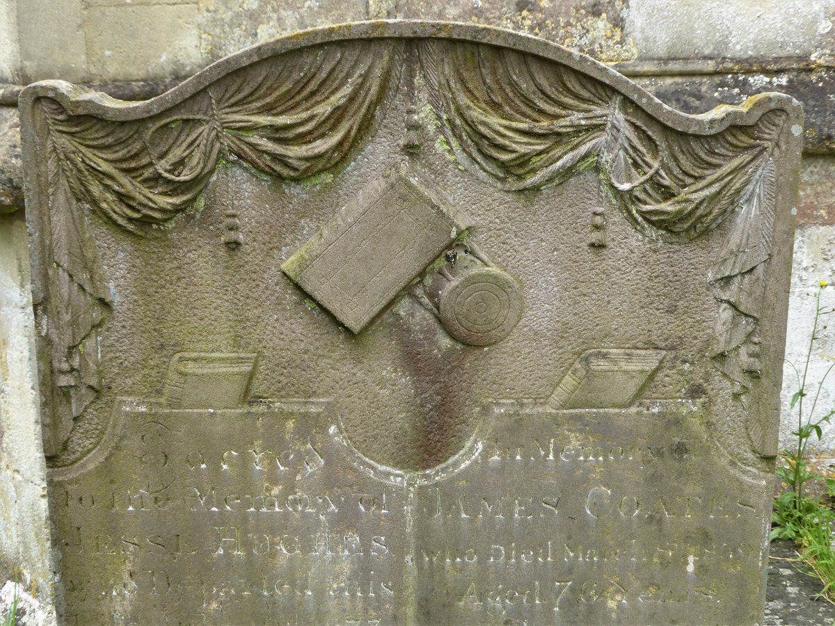 #MonumentsMonday in the churchyard in Marshfield, Gloucs.

Is that the hourglass that died of perspective, scooting behind the book, centre?  See the close-up below & let me know what you think. ⏳

I like the 2 books tucked into their neat little slots, & the diminutive tassels.