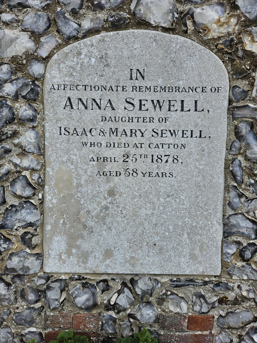 Coming into Lamas. The author of 'Black Beauty' Anna Sewell's headstone is reset in the wall of the former Friends Meeting House.
