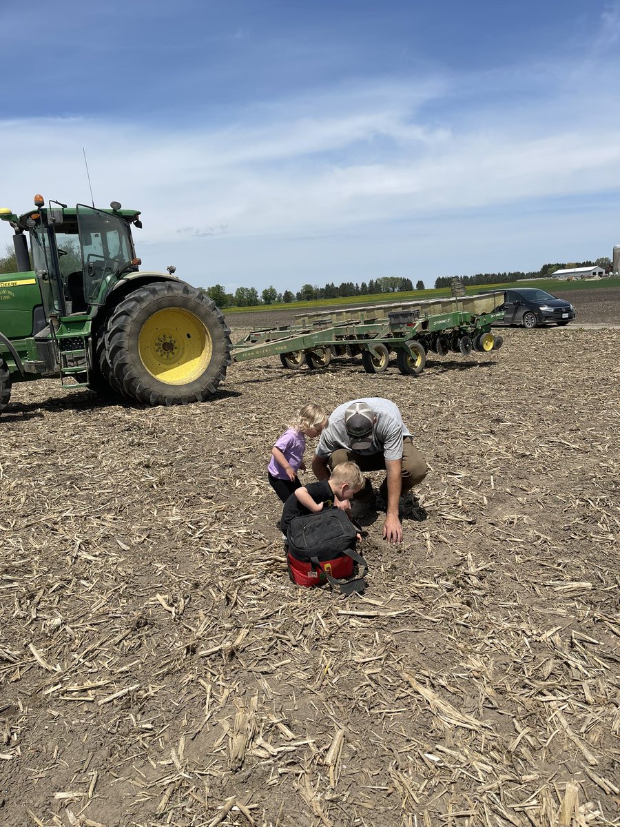 The kids love checking the seed depth with their daddy #DEKALBLittleHelperGiveaway