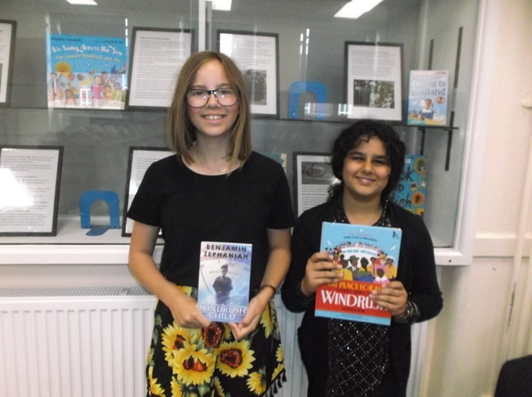 lodeheathschool's tweet photo. Students Celebrated cultural diversity by wearing dress from their heritage and many students took the opportunity to show off their colourful garments, posed by the Library's display celebrating the 75th anniversary of the arrival of the 'Windrush' immigrants from the Caribbean. https://t.co/SszJ85jGS4