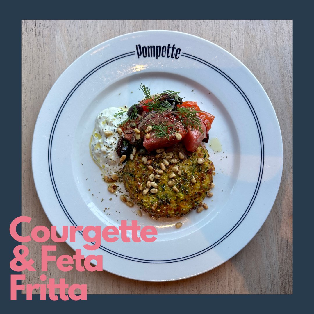 Feast your eyes on this tasty treat! 🤤 💚 A delicious Courgette &amp; feta fritter with Tzatziki, Bull’s heart tomatoes, kalamata olives &amp; pine  Perfect for a light lunch! #veggie #fritters