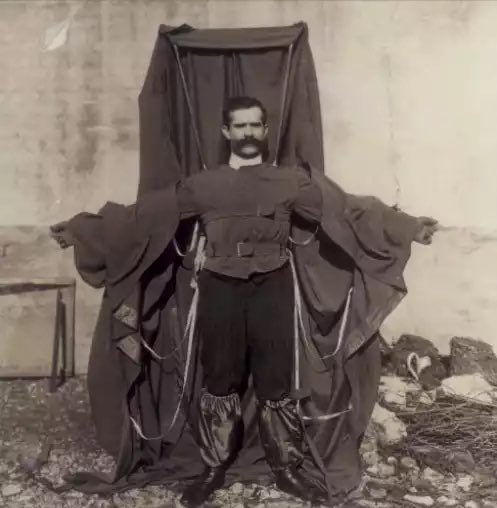 Franz Reichelt, also known as the 'Flying Tailor,' was an Austrian-born French tailor who gained notoriety for his daring stunt involving a parachute of his own design. The provided photograph captures a pivotal moment in his ill-fated attempt to jump off the Eiffel Tower in