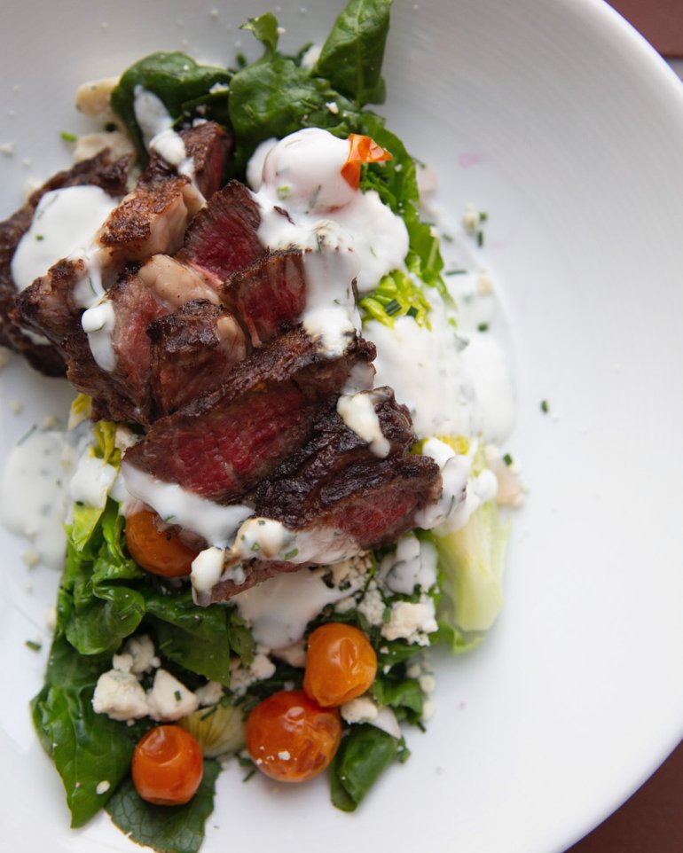 Craving a hearty salad? This is it! 😍 

Our savory Grilled Bavette Steak combines tender steak, marinated tomatoes and blue cheese dressing over local baby gem lettuce. Available for dinner in Heritage Bar Thursdays through Saturdays. #SteakSalad #HealthyEating