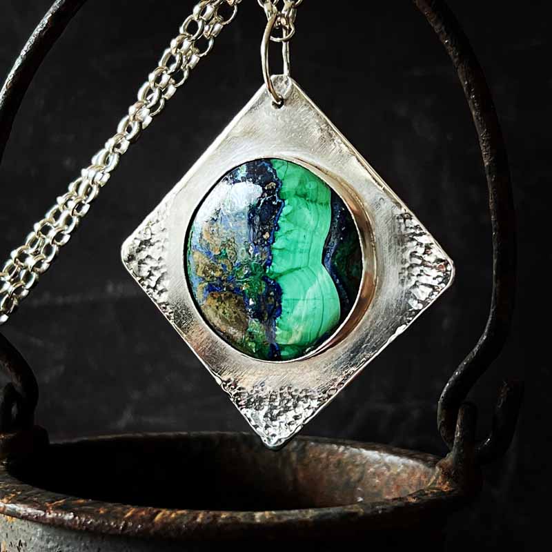Azmalite pendant by Alf. Greeny blue round Azurite Malachite set into a square piece of sterling silver with hammered corners. Chain and handmade clasp are both sterling silver. #malachite #azurite #contemporaryjewellry #sterlingsilver #jewelleryartist #colourful #jewellery