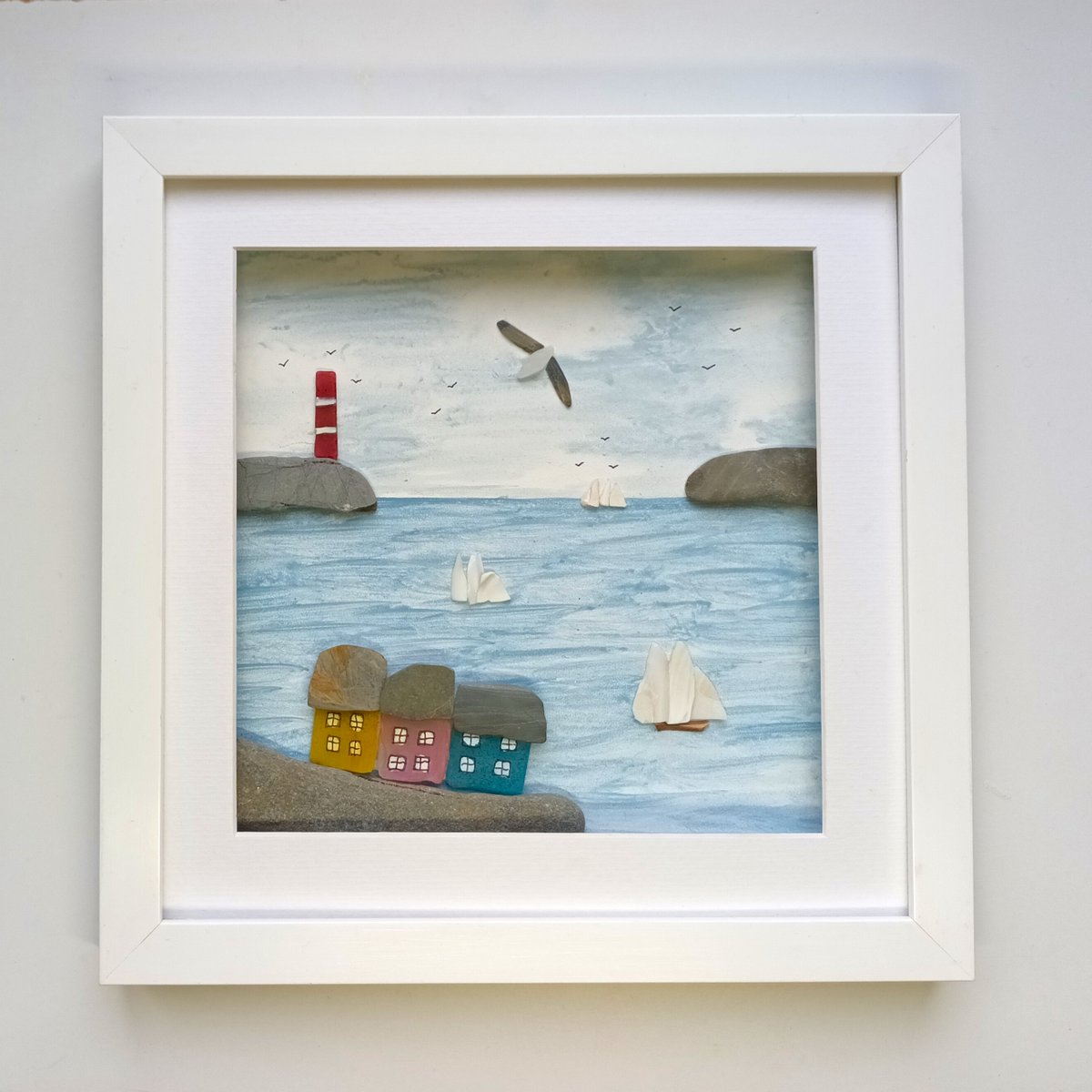 Beachstreetart's tweet image. Sea glass cottages and sea shells sailing boats set in a 29cm square glazed frame #beachcombed #wallart #seaglass #seashells etsy.com/uk/beachstreet…