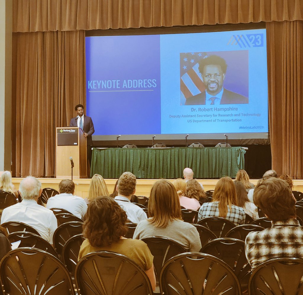 kdlucas04's tweet photo. Dr. Robert Hampshire (@Research_USDOT) addresses #MetroLab2023 + highlights the importance of #civicresearch in creating new + meaningful projects that influence mobility for + with our local communities. https://t.co/LSo96aD4Nk
