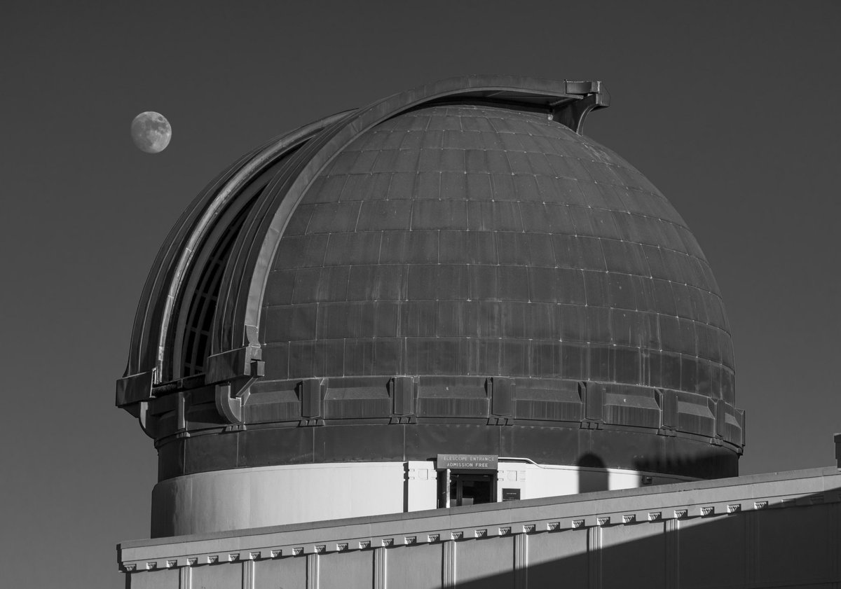 On June 15th, we posted a photograph by Peter Aiello of the moon peeking between the coelostat and Samuel Oschin Planetarium domes. Today, we're showcasing a classic black and white picture taken by Observatory Museum Guide David Pinsky of the moon beside the Zeiss telescope dome