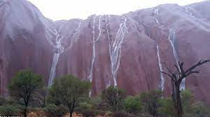 This photo of rain pouring over Uluru. 

So beautiful.