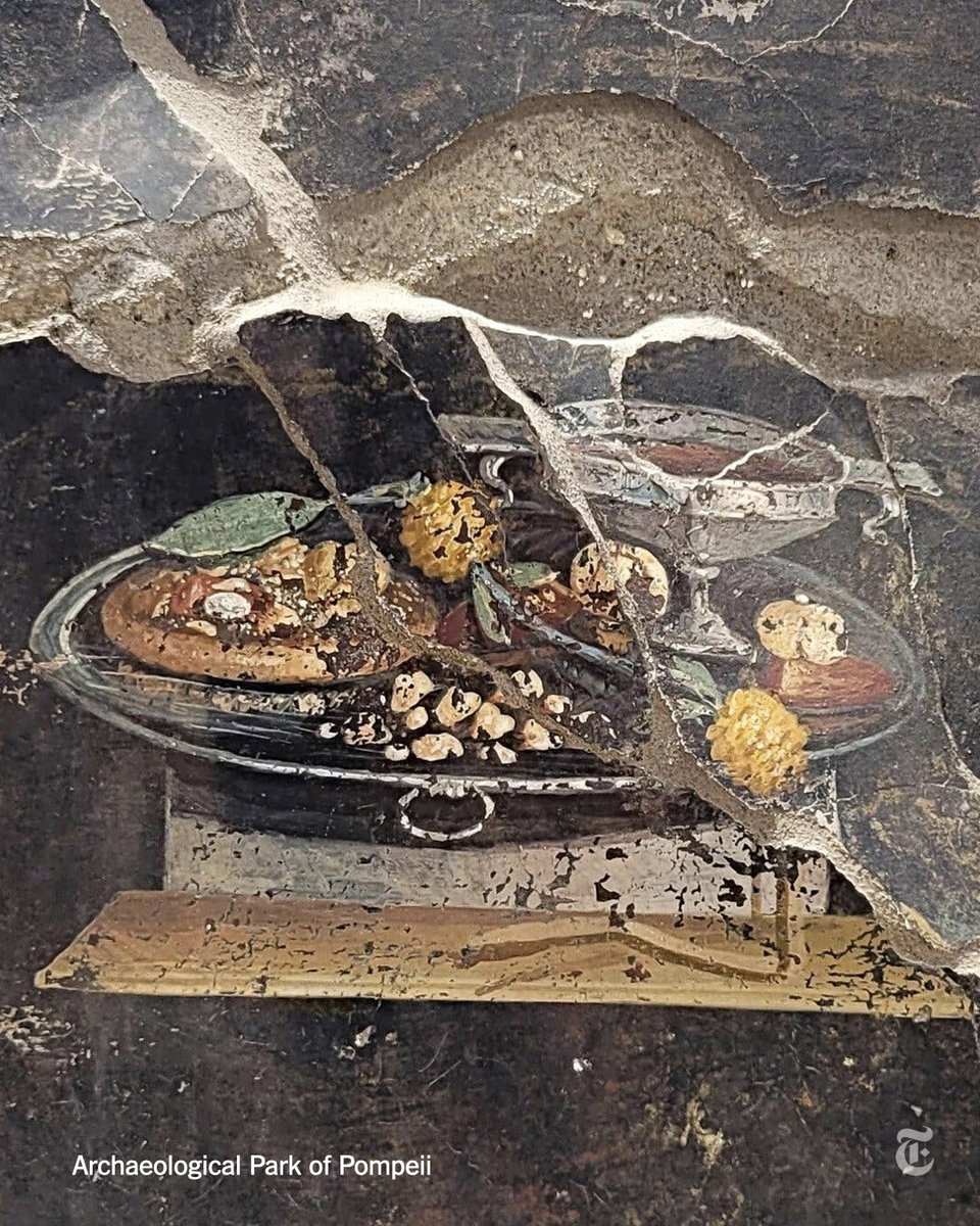 This 2,000-year-old painting discovered in the ruins of Pompeii shows what may be a distant ancestor of modern pizza: a flat, round piece of dough with toppings. But it's not a pizza, the archaeologists who found it insisted on Tuesday.  nyti.ms/44gPsSh
