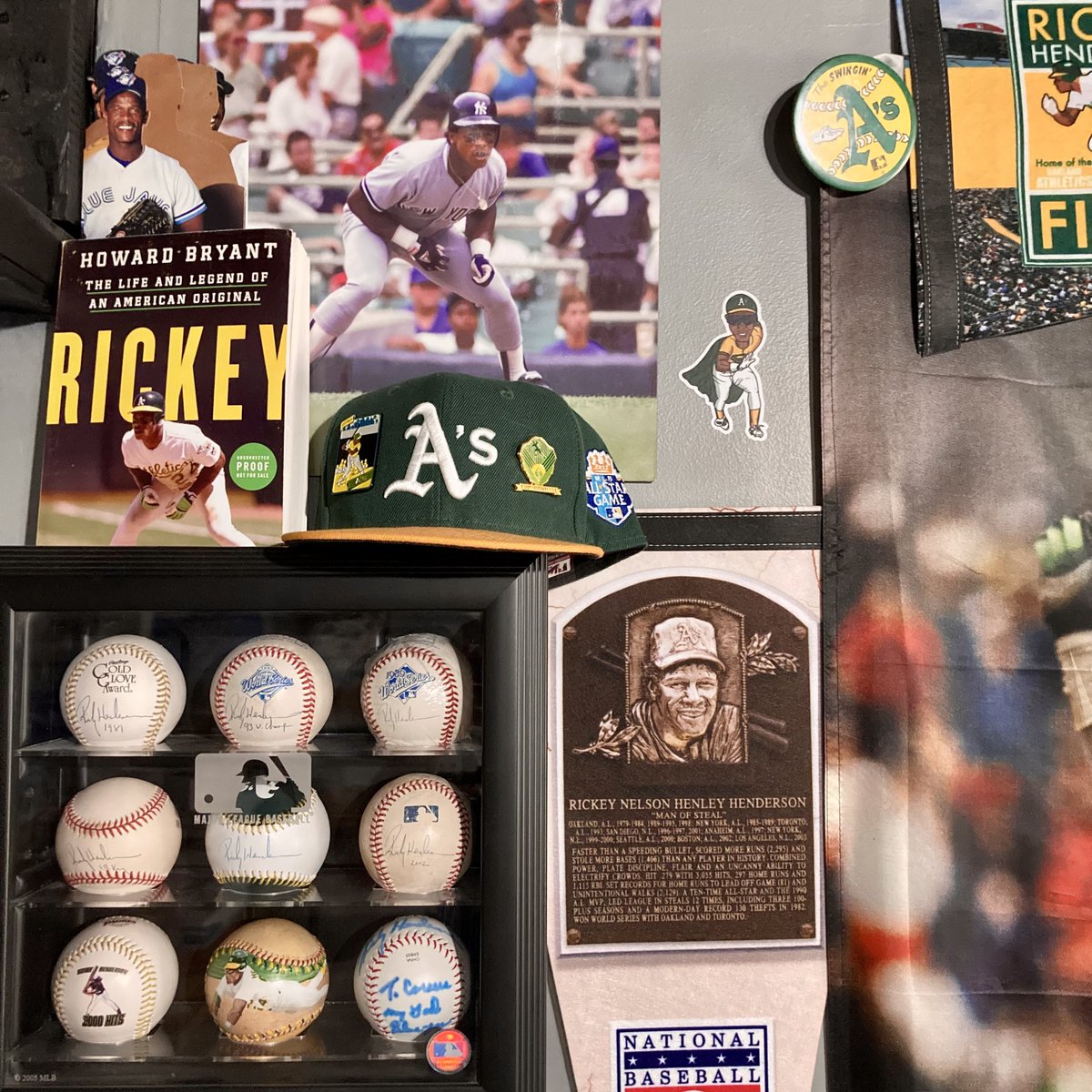 Todays Rickey Henderson PC swag is this current view within the “Man-cave of Steal” that captures bling from baseballs, pins, hats, pennants and more. Can you guess how many @MLB teams are represented in this one image? @CardPurchaser 🔥💚👀🐐⚾️🏃🏿💨🧤#rickeyhenderson #thehobby