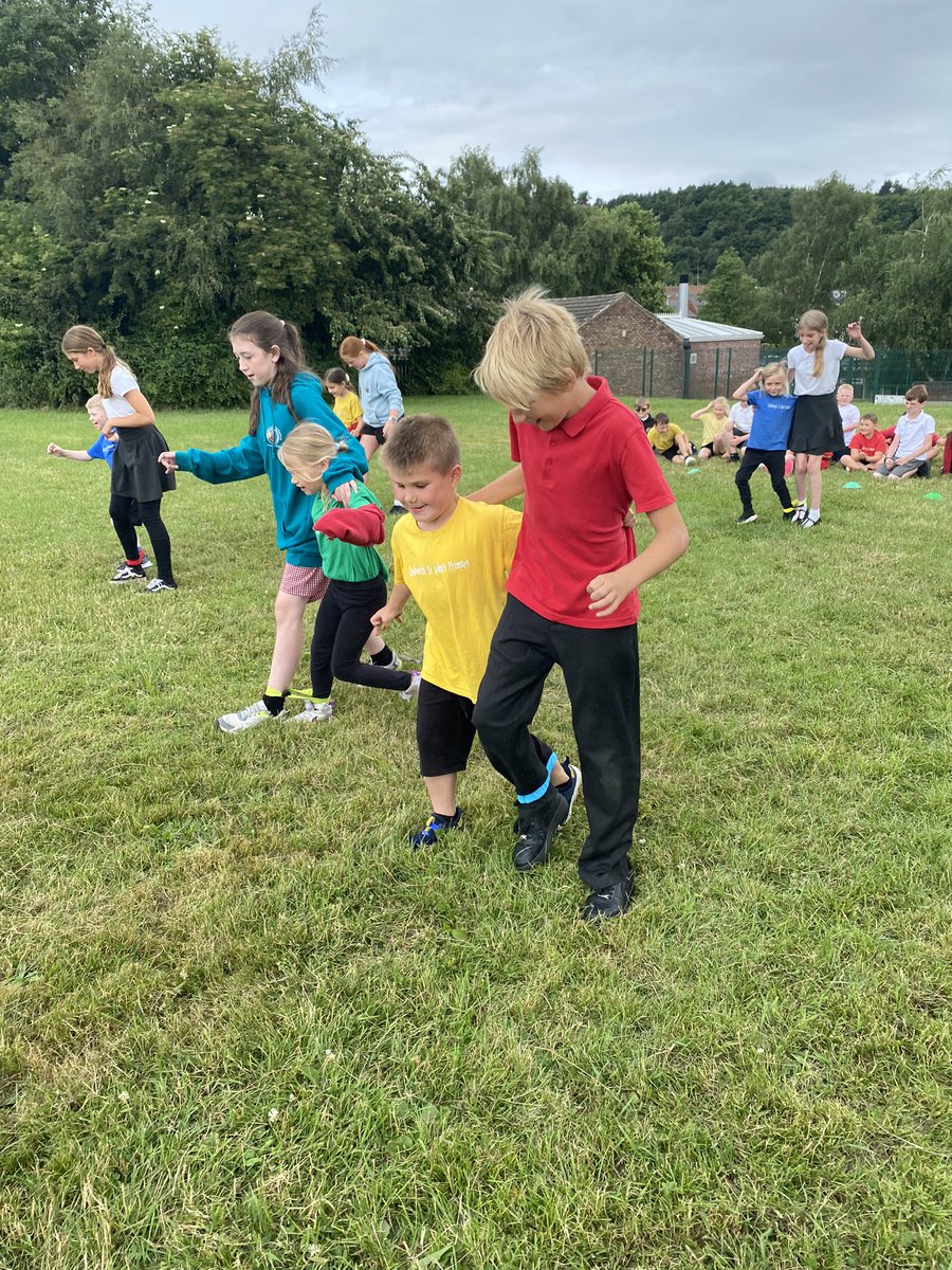 DSJ_Year6's tweet photo. Y6 Showing Y1 how to do the three legged race ready for sports day. https://t.co/uH1DwHN3Z1
