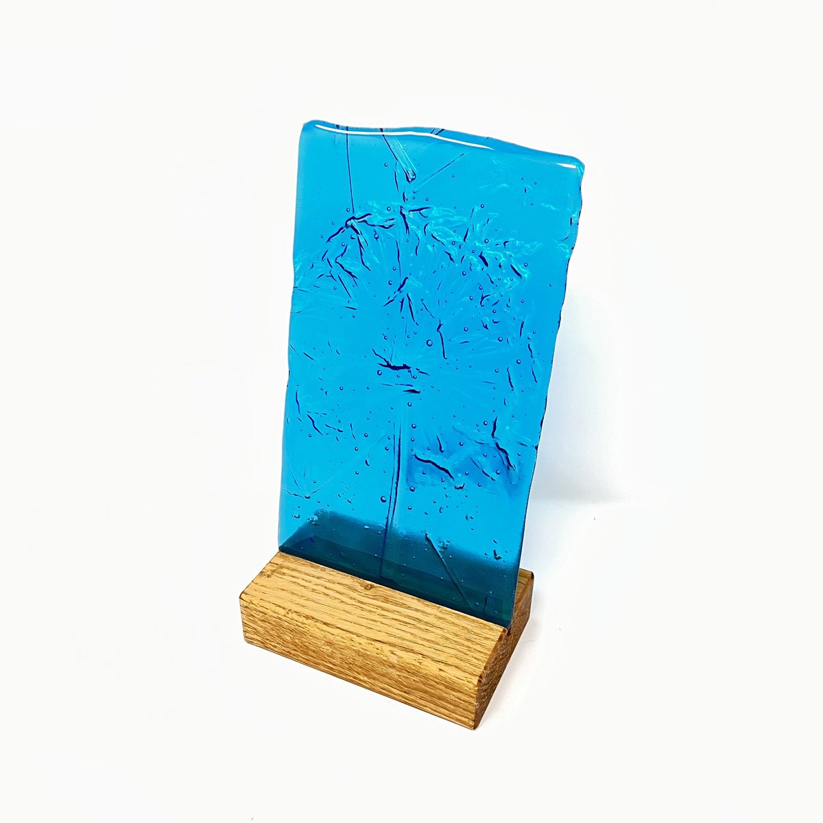 Agapanthus Block by Hilary Shields Iridised glass with hollow relief of a single agapanthus set in an oak block. Ideal for a candle or sunny window sill #agapanthusflower #supportlocalbusiness #tonbridgehighstreet #summer #inspiredbynature #artforthehome #botanicalart