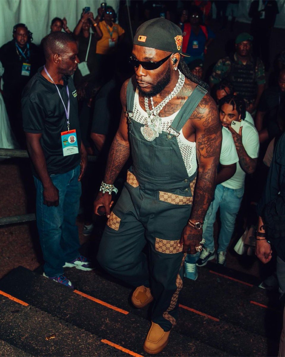 Burna Boy wearing Gucci cotton canvas dungarees for his St.Kitts music festival performance. 🤩