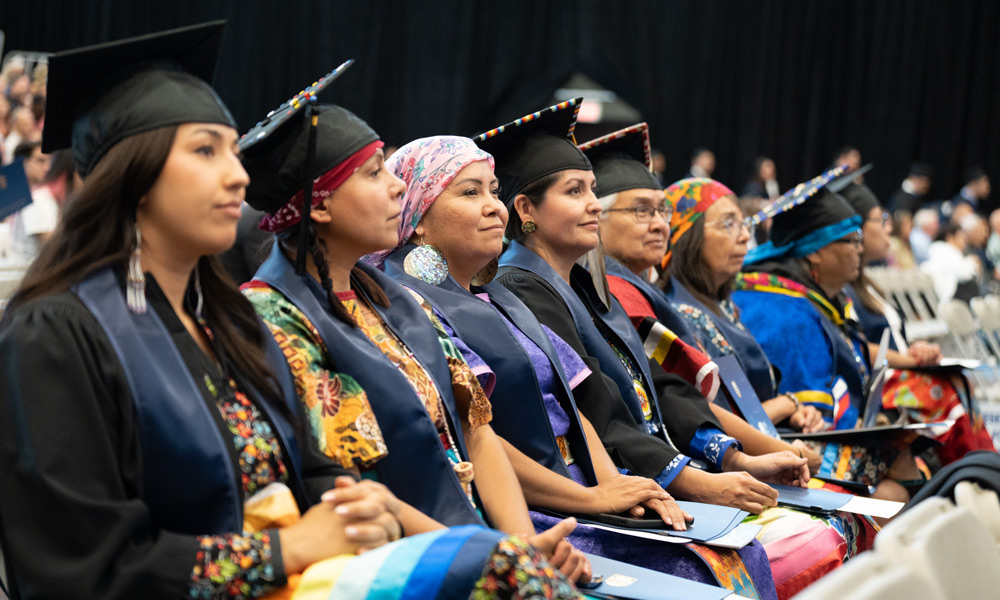 UBC's tweet photo. For the first time in history, eight Syilx @ubcokanagan students graduated with a degree taught in their language and delivered on their land. 

Learn more about the first Bachelor of Nsyilxcn Language Fluency program cohort: https://t.co/yxZkMua70p https://t.co/G0Faruz5rg