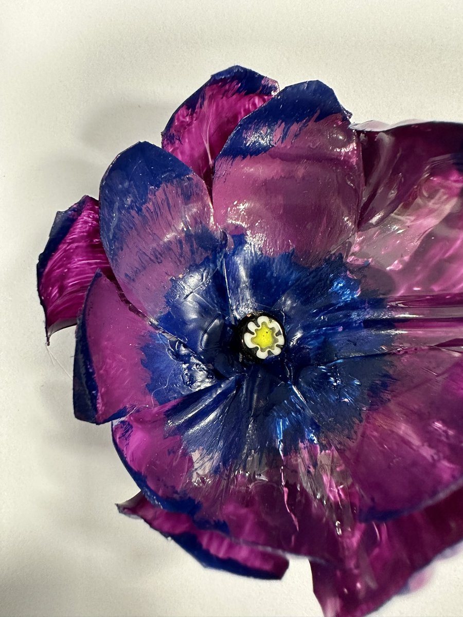 Experimenting with recycled materials (plastic bottles and heat) to make flowers - love this outcome!