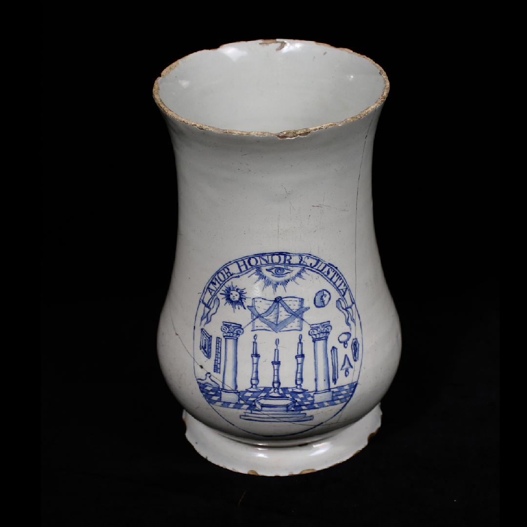 Are you a fan of early ceramics? Then you'll love this delftware favourite from our collections! Made in 1740, it's one of the earliest ceramic pieces in the collection. It has a blue-grey coloured glaze and a pedestal base. #LondonHistory #HistoryOfCeramics #Freemasonry 1/3