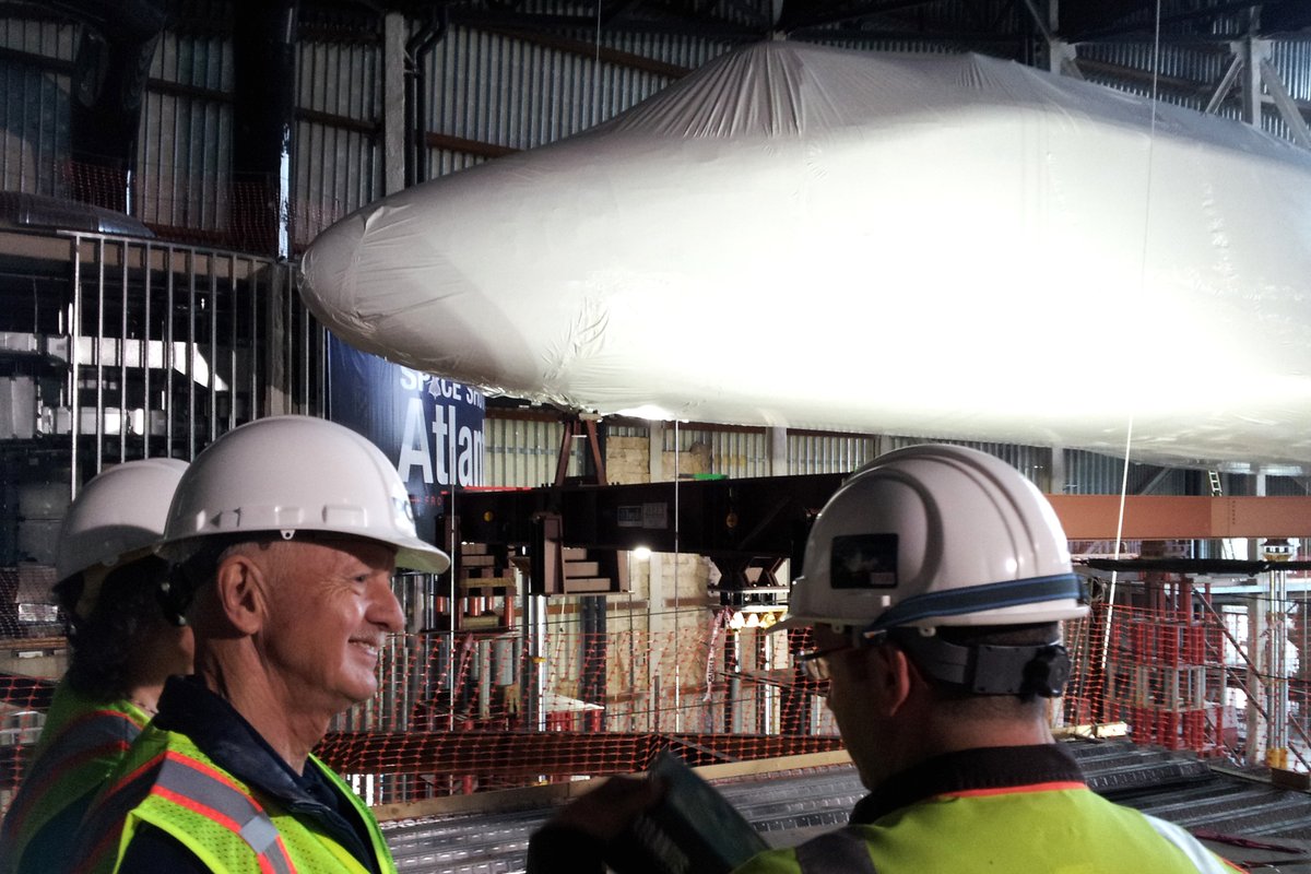 WordsmithFL's tweet photo. @ExploreSpaceKSC J.D. Bartoe and his wife touring Space Shuttle Atlantis exhibit construction, November 19, 2012.  From my personal collection.  Note that Atlantis is still horizontal, not yet at 43.21°. #Atlantis10 https://t.co/I92DCGtuDd